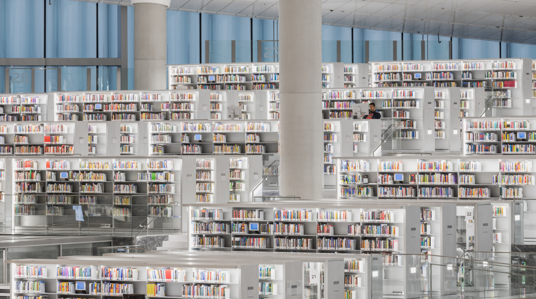 A spacious library filled with numerous books neatly arranged on tall shelves.