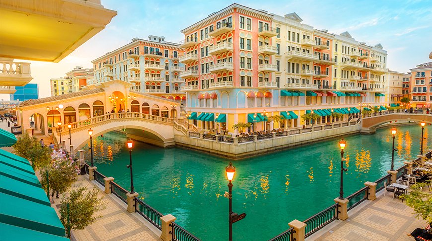 A city canal surrounded by buildings and people enjoying the urban landscape.